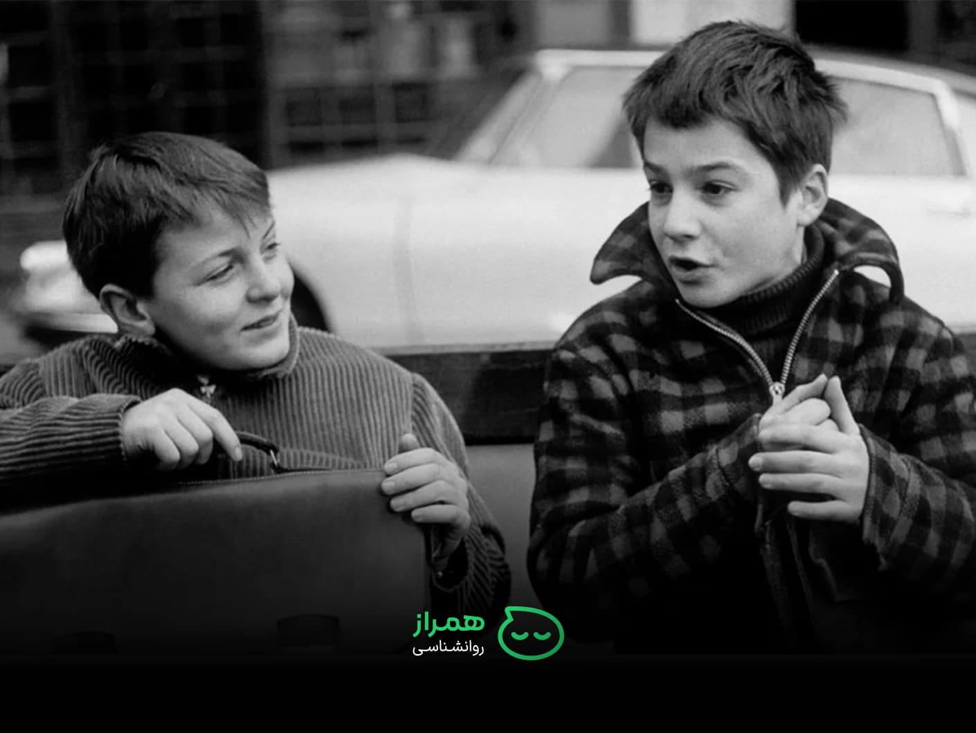 Two schoolboys talking together – childhood friendship and shared emotions