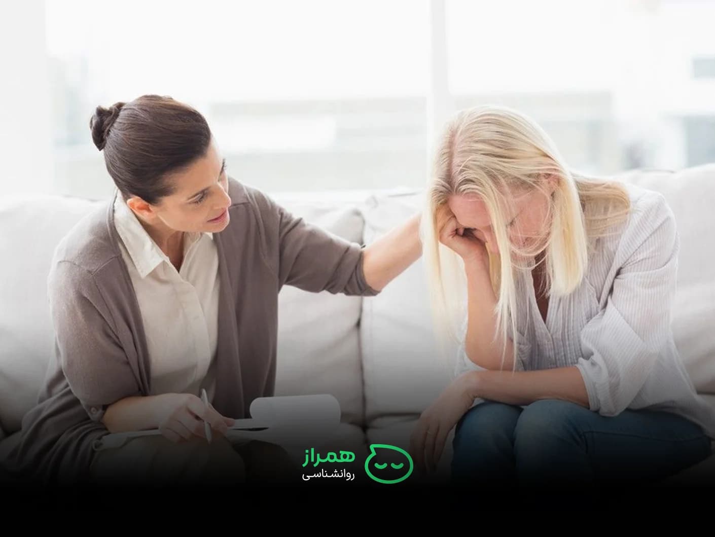 Therapist comforting a crying woman during emotional counseling session